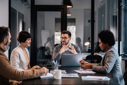 A team discussing a business process around a meeting table