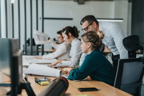 Colleagues working together at their desks