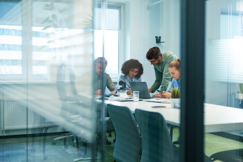 A team working through a question in a meeting room