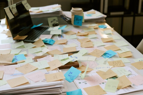 A desk covered with notes and documents